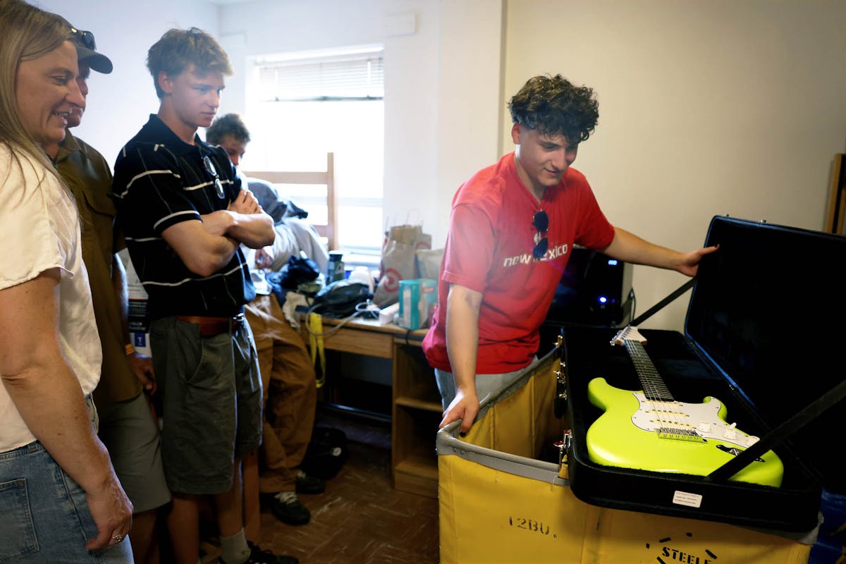 First-year student Will Healy, right, shows off his guitar that took him a year and a half to make, during move-in and the first day of New Student Orientation. Photo by Jamie Cotten / Colorado College